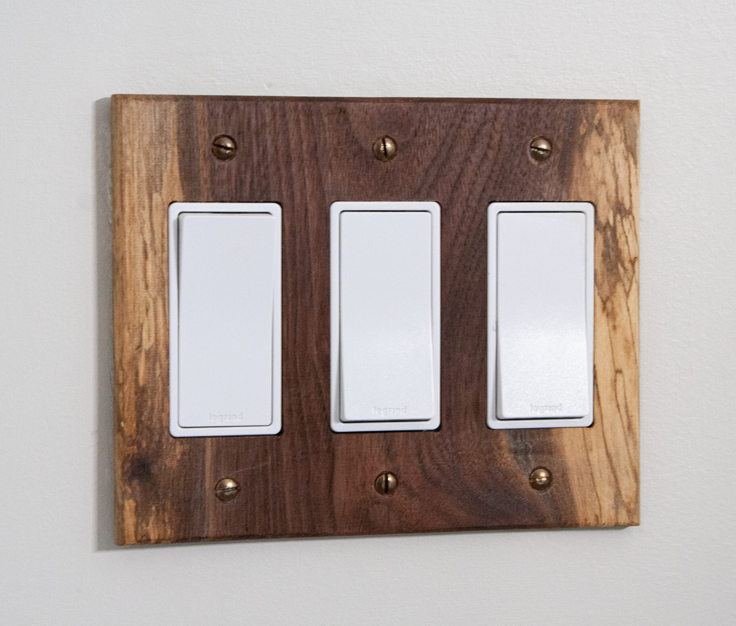 black walnut light switch cover with spalted figure on the outsides of the plate